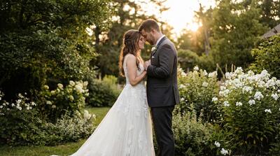 Bride and groom sharing private intimate moment in quiet garden setting
