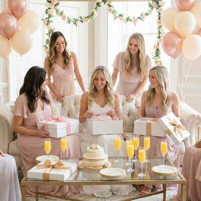 Bridal shower celebration with friends gathered around bride opening gifts (Matrimonio)